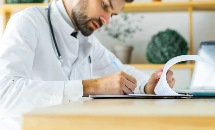young-medical-practitioner-making-notes young-medical-practitioner-making-notes